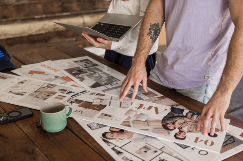 Designer arranging brand collateral on a workbench
