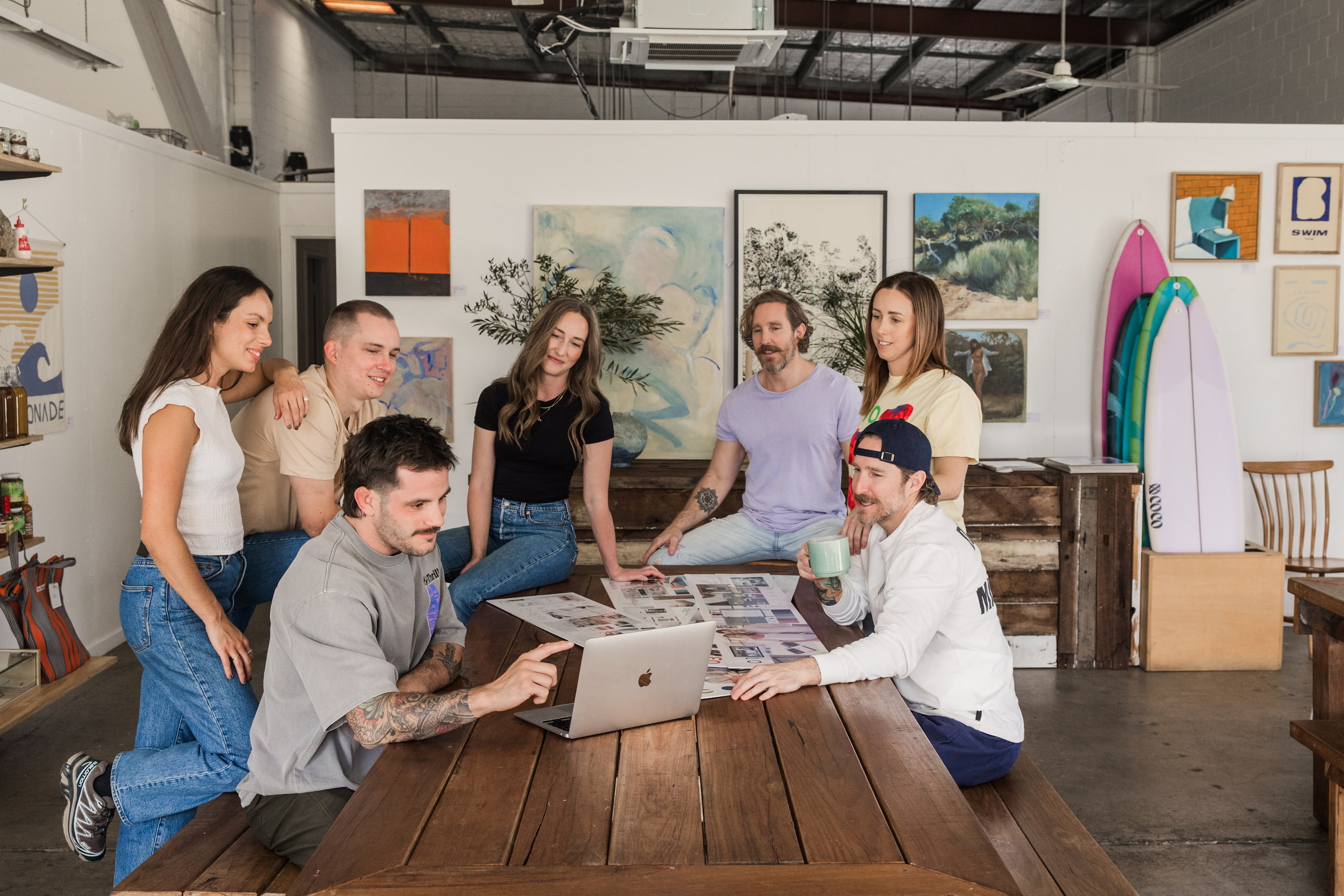The Embark team gathered around a laptop in the studio